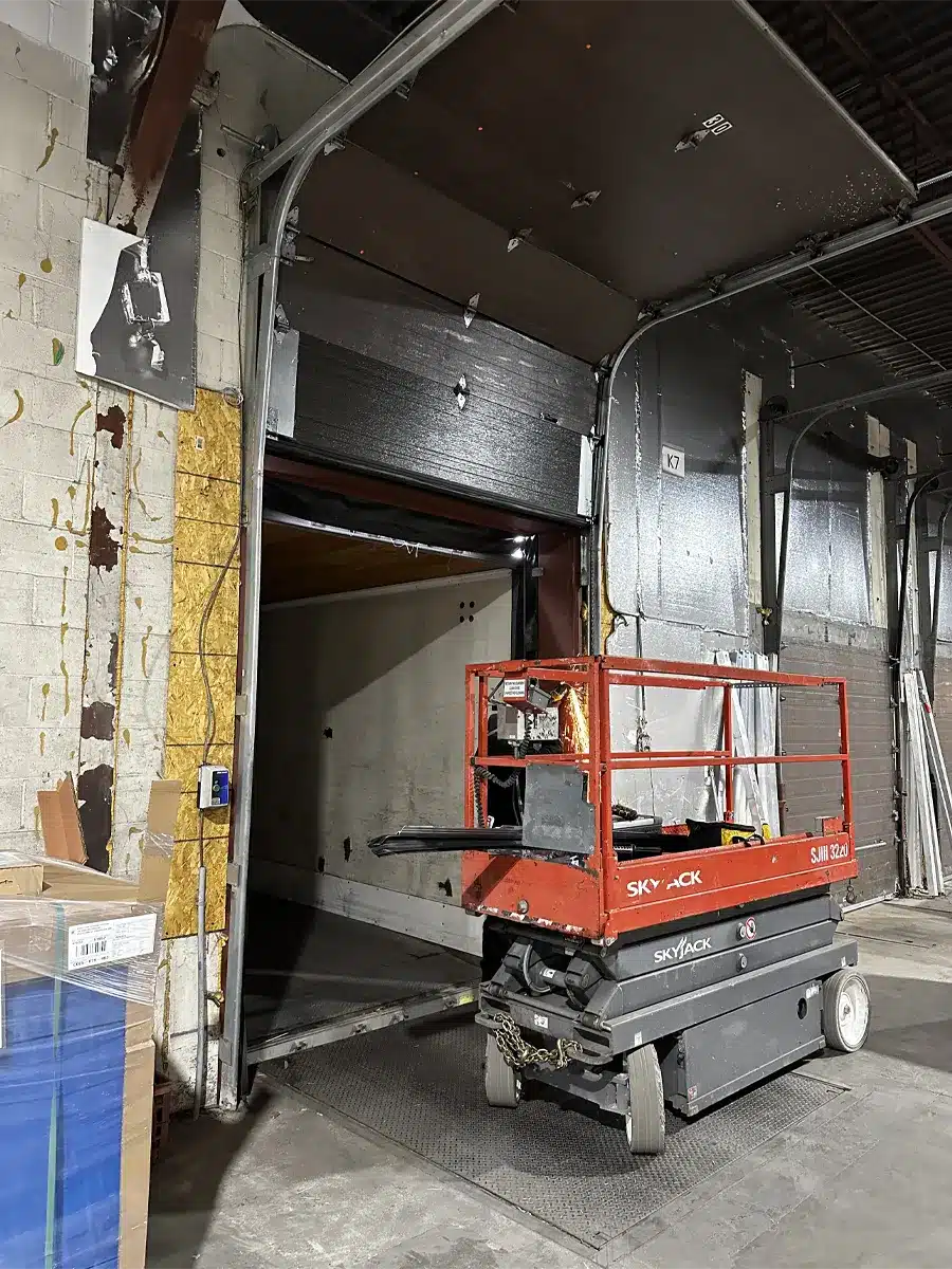 a technician from Unique Garage Door changing garage door in Beaconsfield