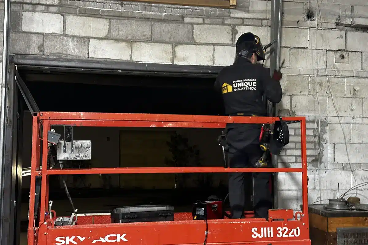 a garage door repair specialist using advance equipment like scissor lift to install a new garage door in Blainville