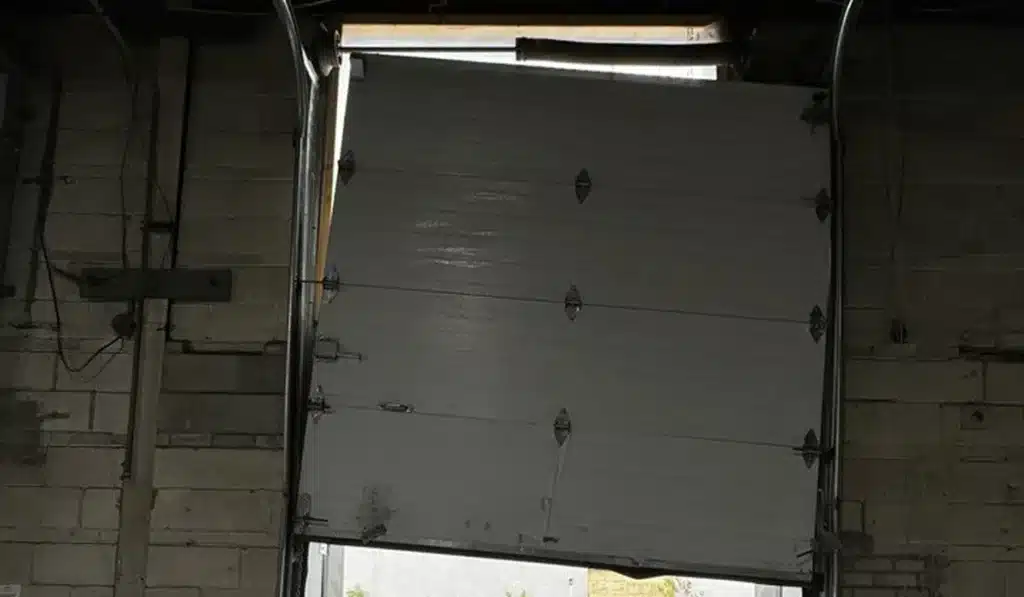 A broken garage door in a Montreal property that requires urgent repair service.