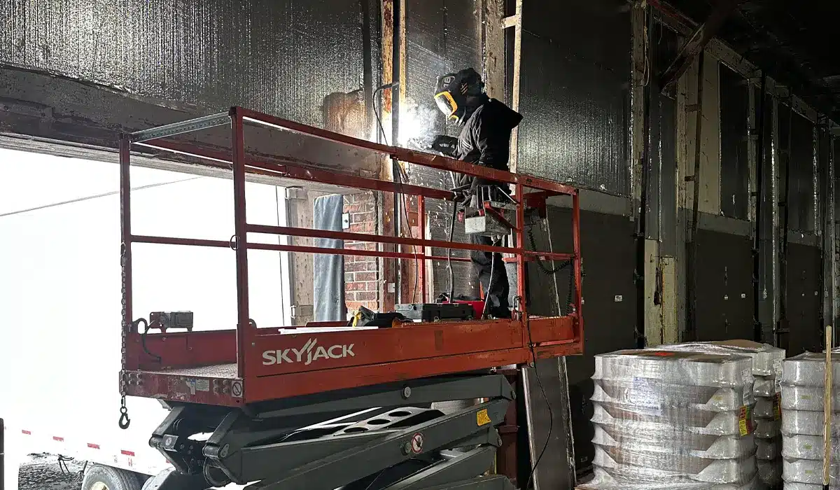 A technician from Unique Garage Doors repairing a garage doors with advance equipment for a quality services in Laval