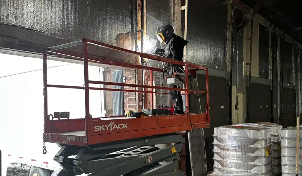 a garage door specialist from Unique Garage Doors is installing new garage door in Montreal fully equipped with advance techs