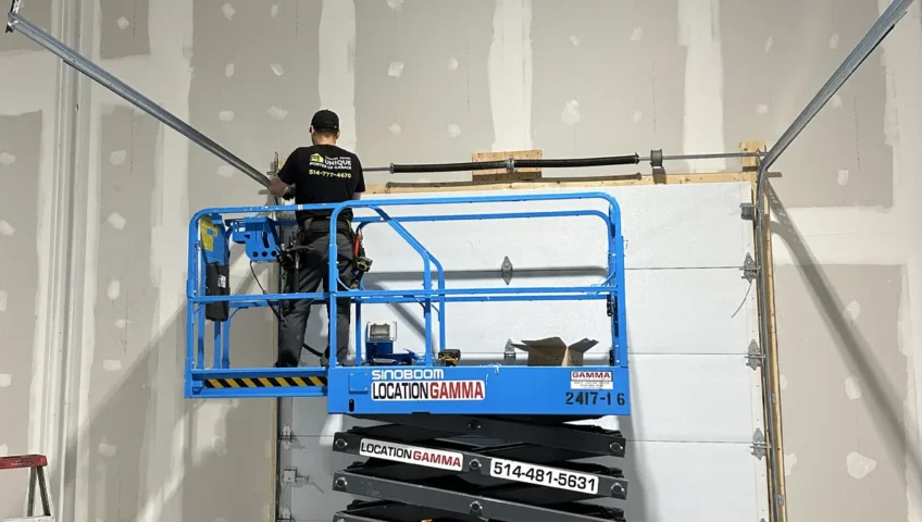 a technician in Montreal conducting a maintenance in a commercial garage door