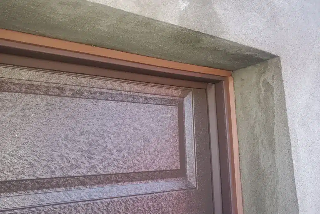 Inspection on a garage door weather stripping before winter