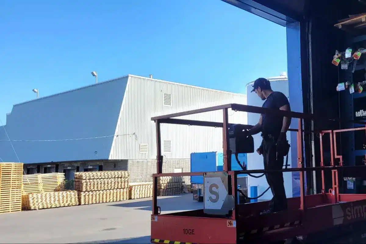 An expert on Garage Door Maintenance Checking on a cables, springs, and panels