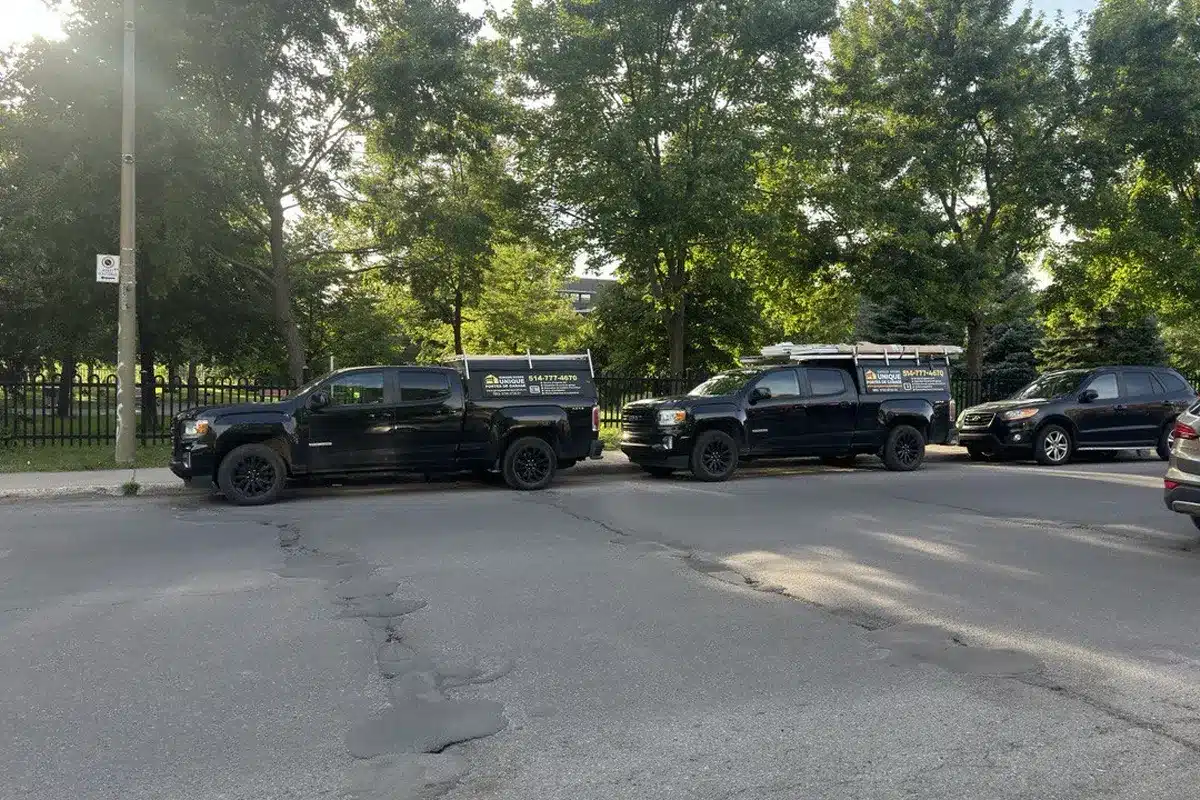 2 service car from Unique Garage Door line up for a Garage Door Maintenance
