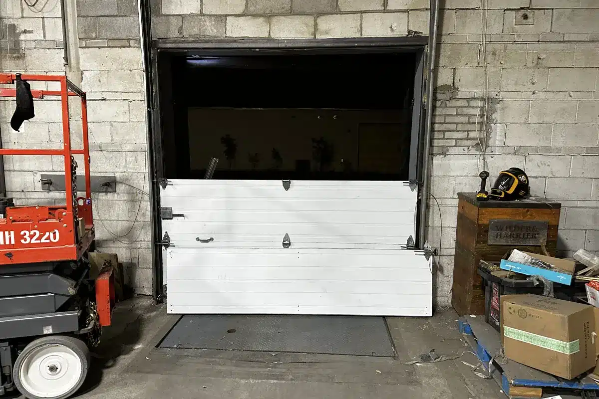 a broken garage door panel is replaced with new quality doors from Unique Garage Door in Dorval
