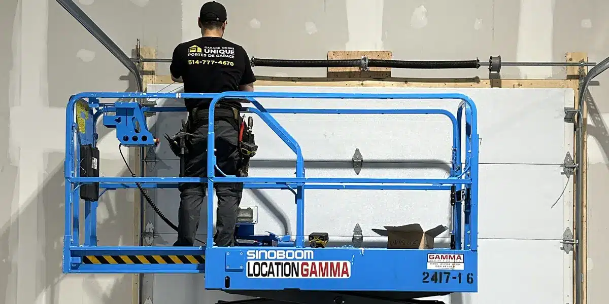 a garage door repair specialist from Unique Garage Door using advance equipment like scissor lift to install a new garage door